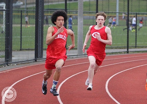 2 track athletes racing around the track